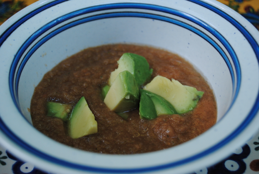 Soup with avocado slices.