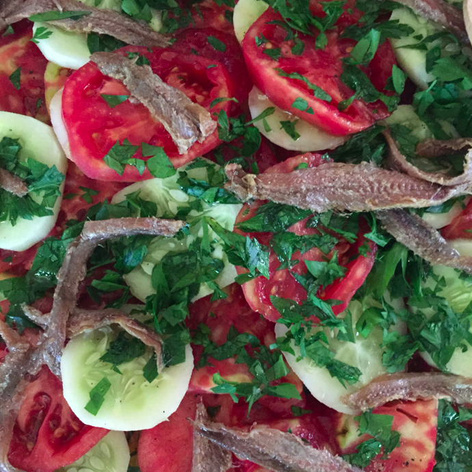 Tomato, Cucumber, Parsley, Anchovy salad. Fresh veggies from the CSA. True perfection.